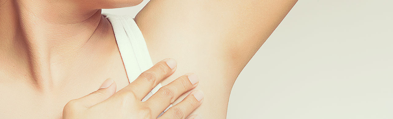 picture of a woman touching her armpit