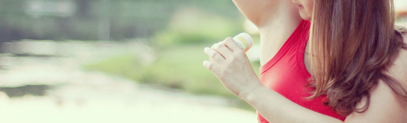 picture of a woman applying deodorant