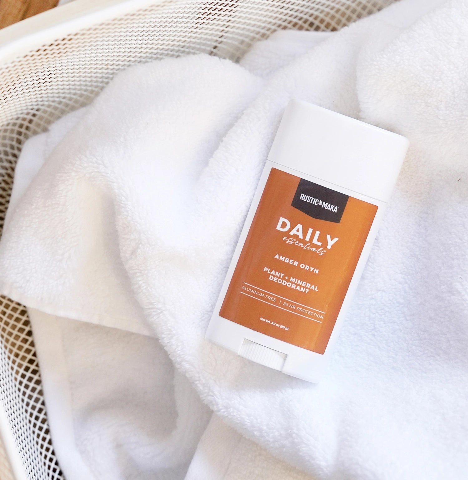 Deodorant stick with a brown label on a white towel