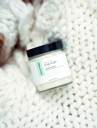 Jar of Luna Bliss body butter on a textured white surface